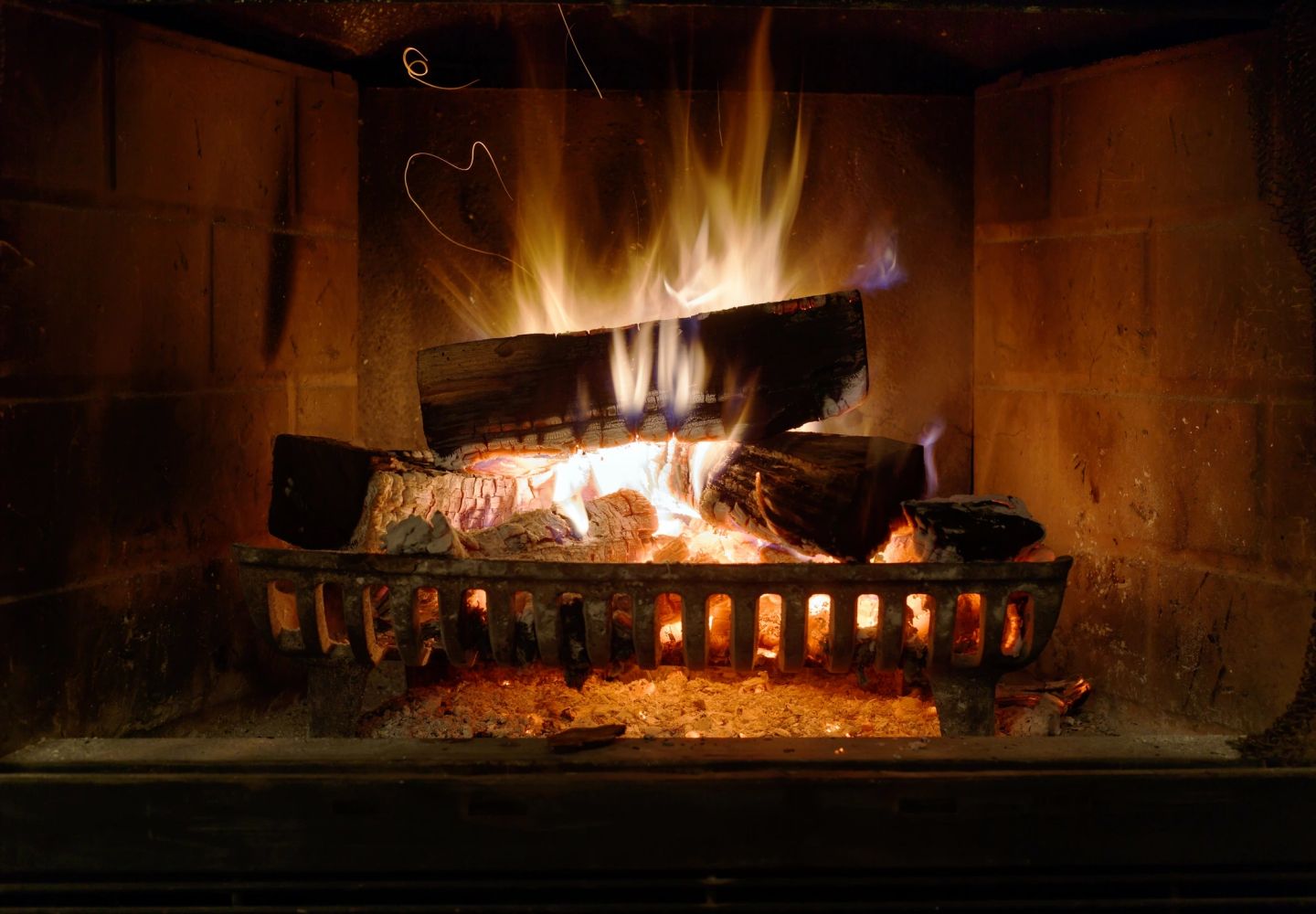 A bright fire burning in a fireplace